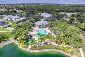 Aerial view of a Southwest Florida golf resort community with a lagoon pool and palms